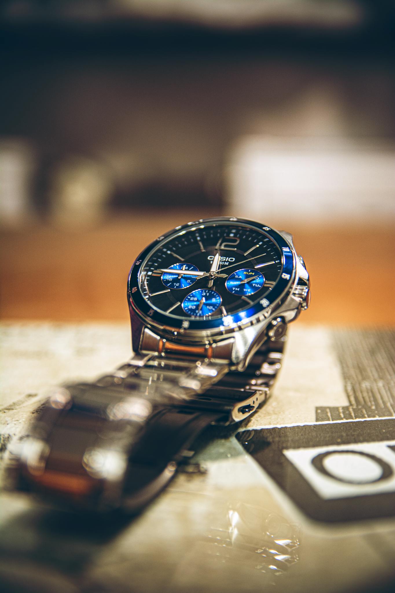Close-up of an elegant Casio wristwatch with a blue dial, showcasing luxury and precision.